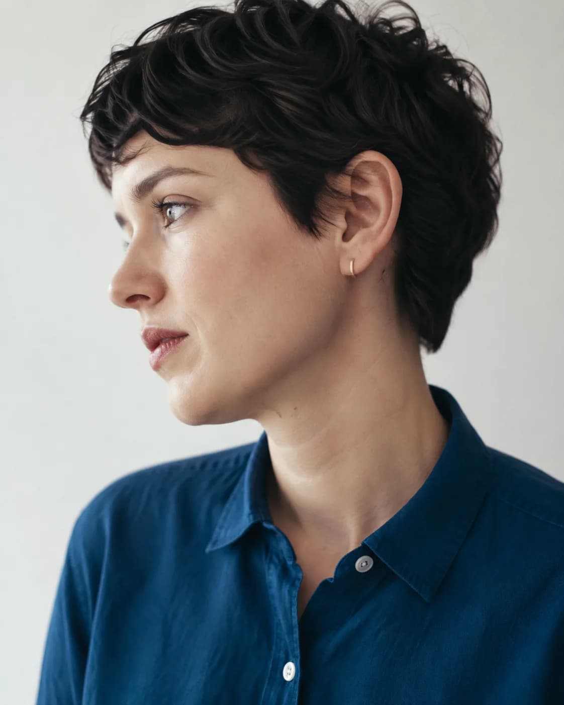Concept editorial portrait of a person in a blue shirt looking to the left