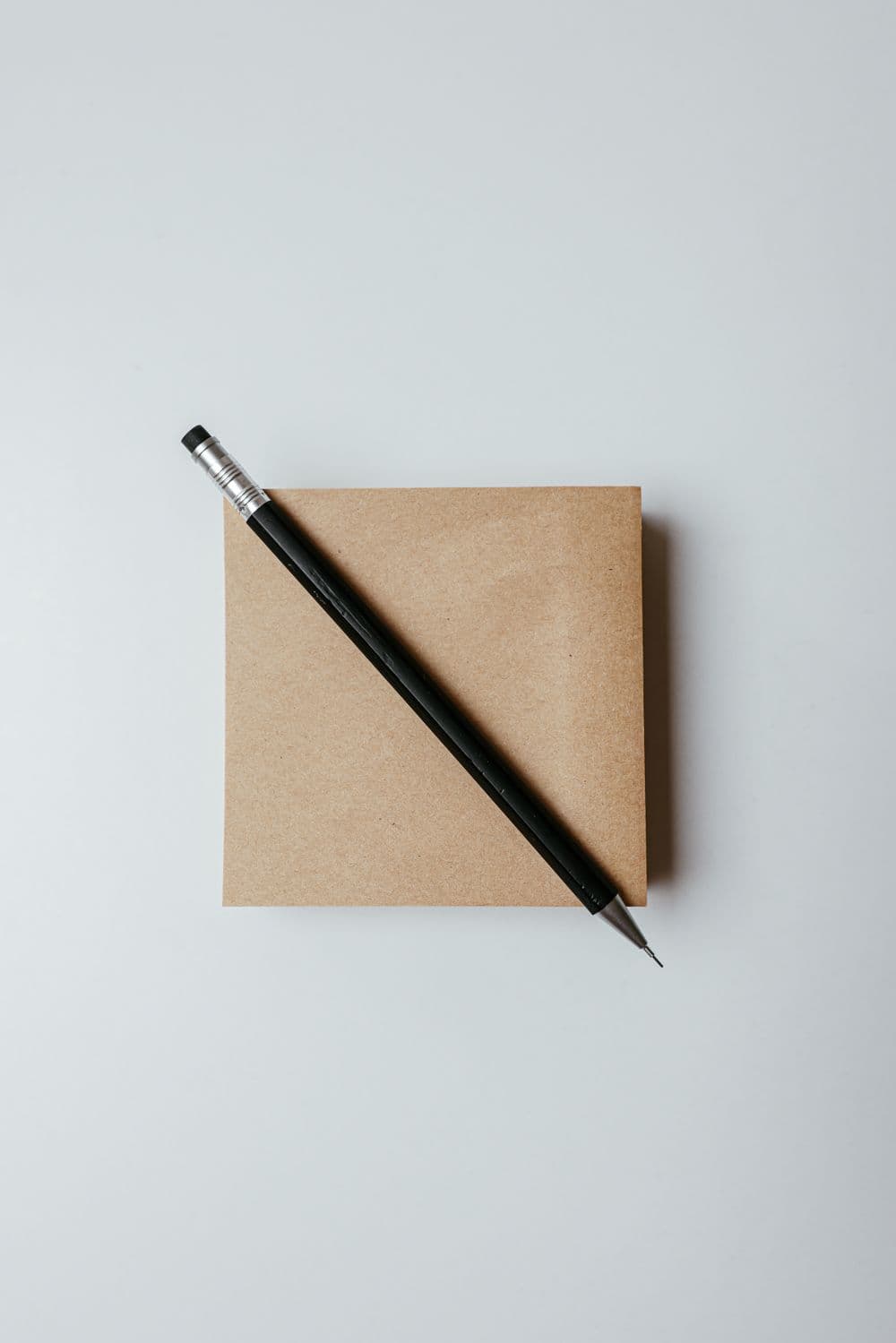 A notebook and pen on a desk, ready for planning a website launch