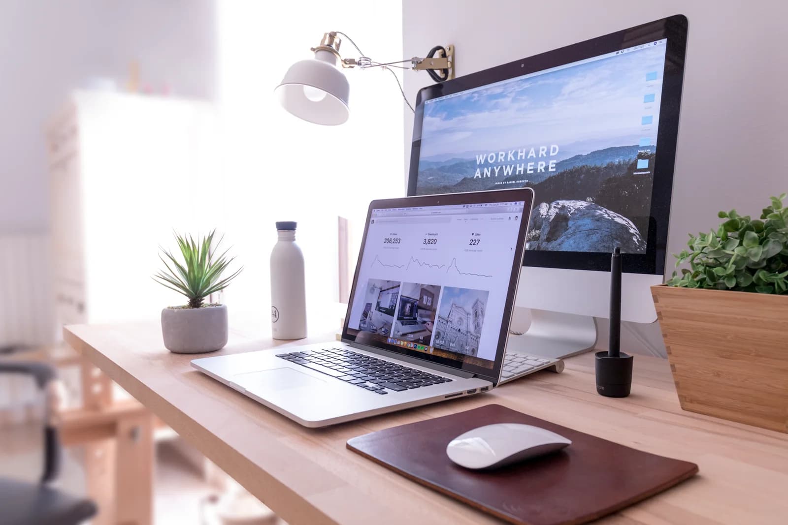 Desktop monitor and laptop showing websites in a bright workspace