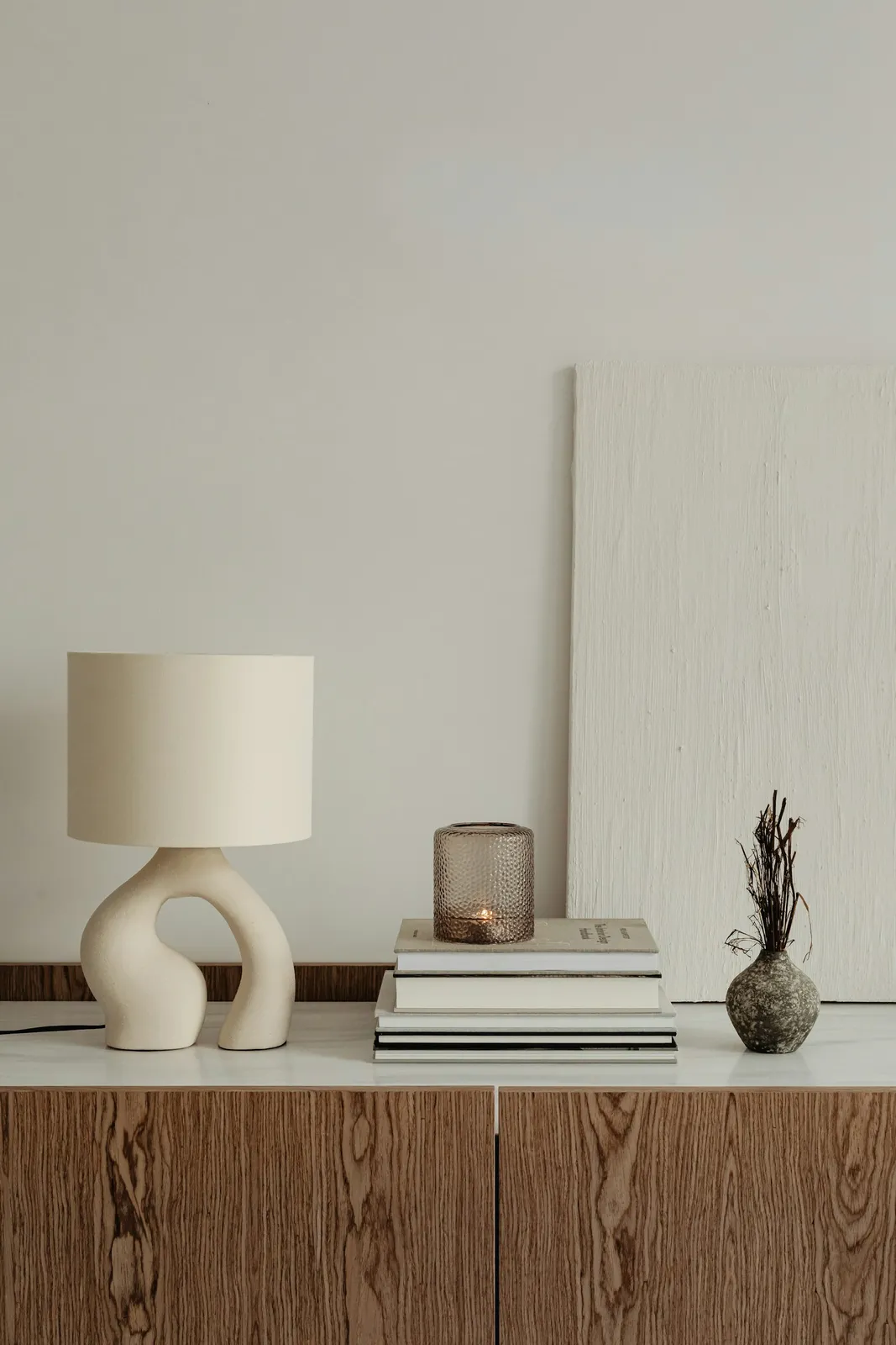 A lamp and books on a table