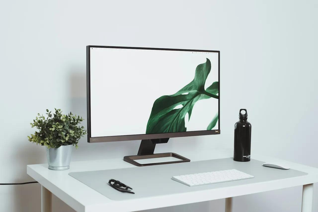 A computer monitor sitting on top of a white desk