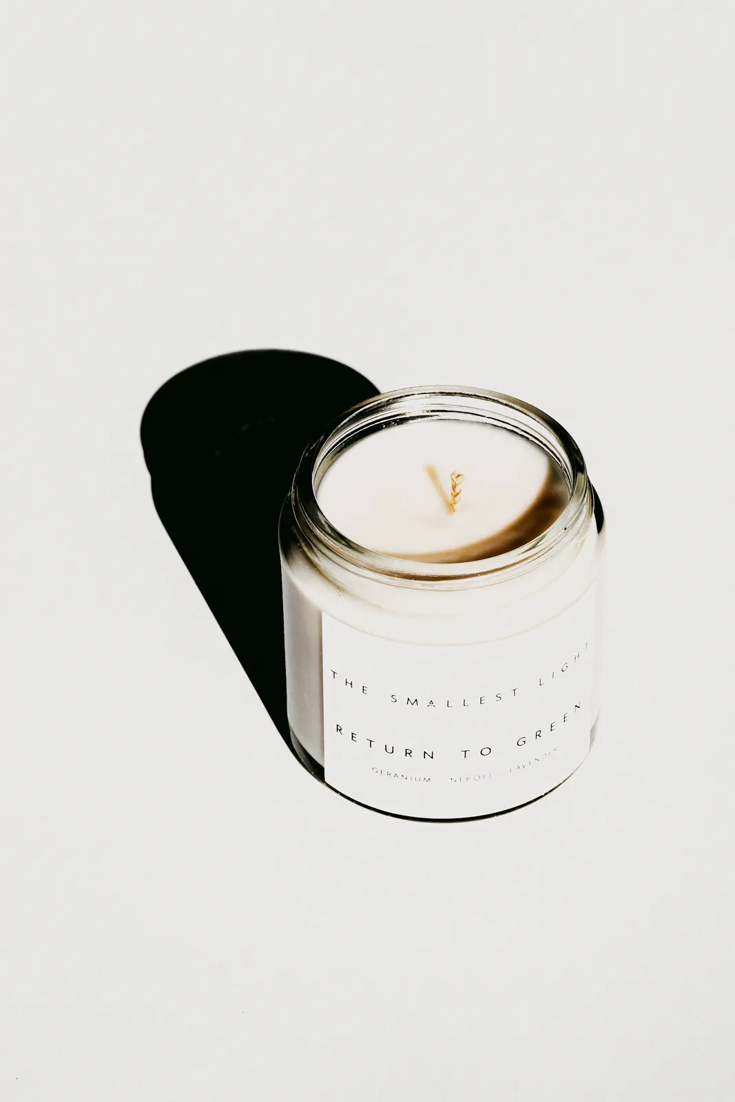 White candle in clear glass container