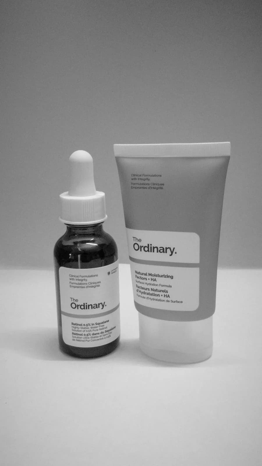A bottle of lotion next to a tube of lotion