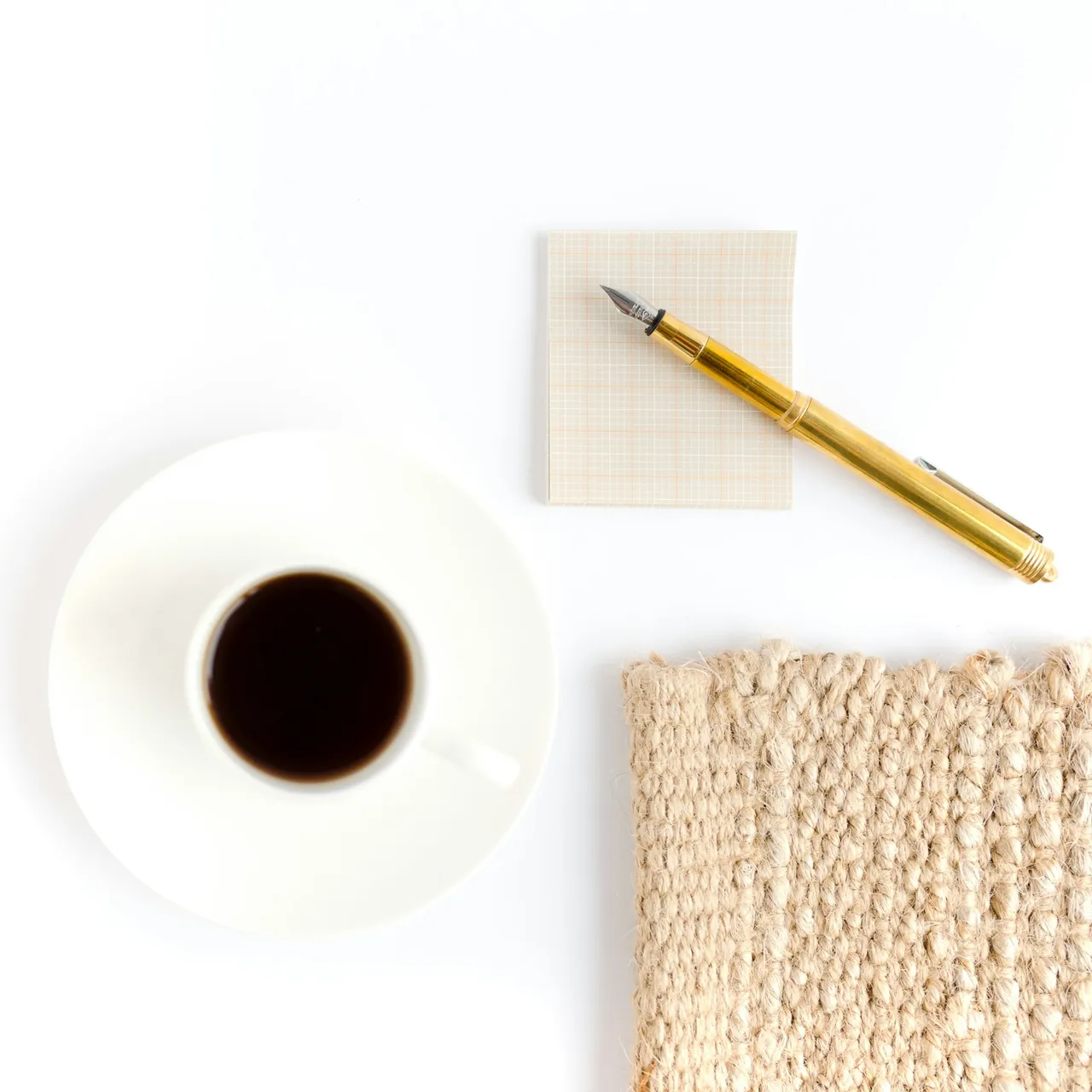 White ceramic mug beside brown pencil on white round plate