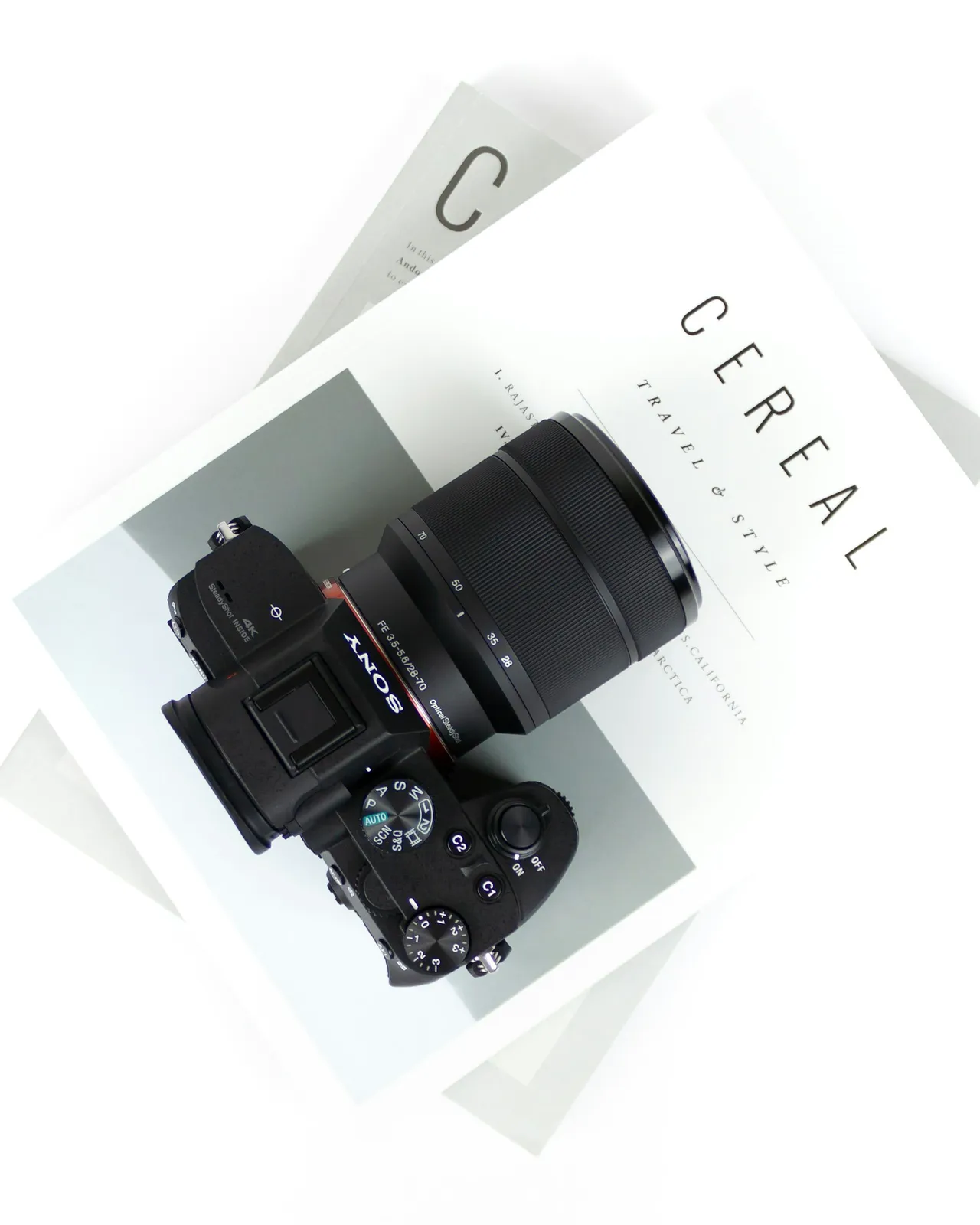 Black DSLR camera on Cereal book