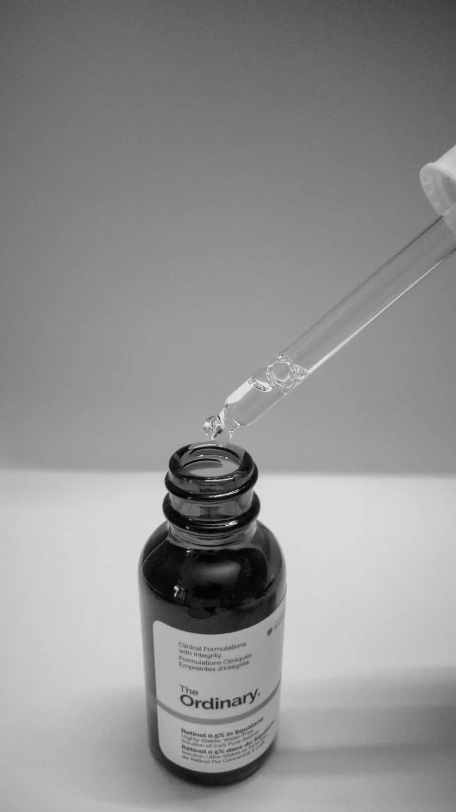 A dropper filled with a liquid sitting on top of a table