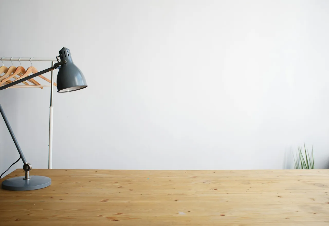Gray balanced-arm lamp on brown wooden table